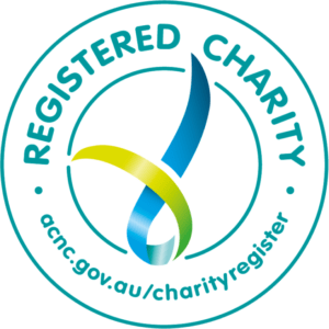 The ACNC Registered Charity logo. This is a teal outer circle, with a teal inner circle and a ribbon logo inside that in a gradient of blue and green. Between the two circles is the text "Registered Charity acnc.gov.au/charityregister"