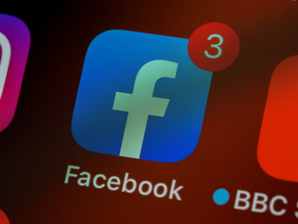 A close up of the Facebook app icon, next to the BBC app icon.
