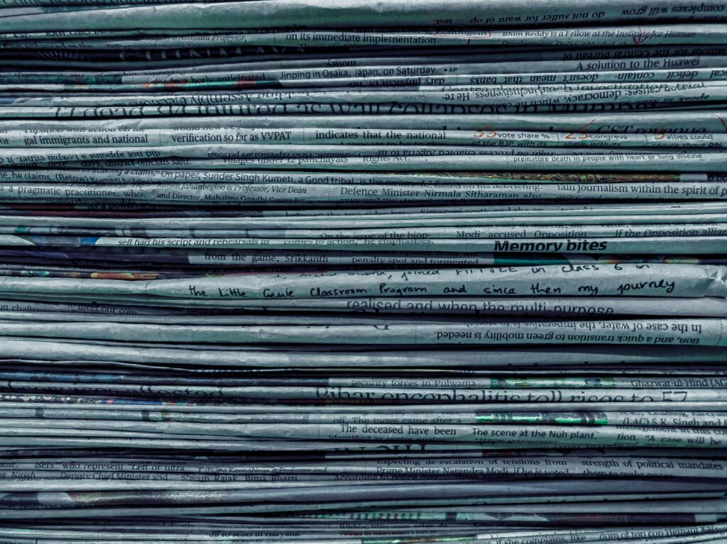 A stack of newspapers, seen from the side.