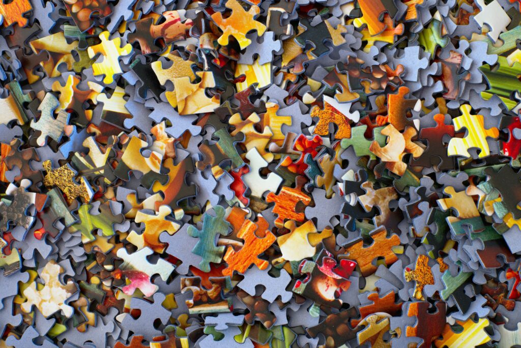 Colourful puzzle pieces in a pile.