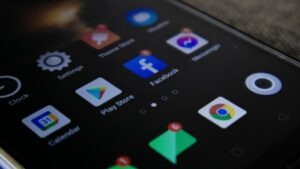 Phone screen showing apps including Facebook and Google Chrome